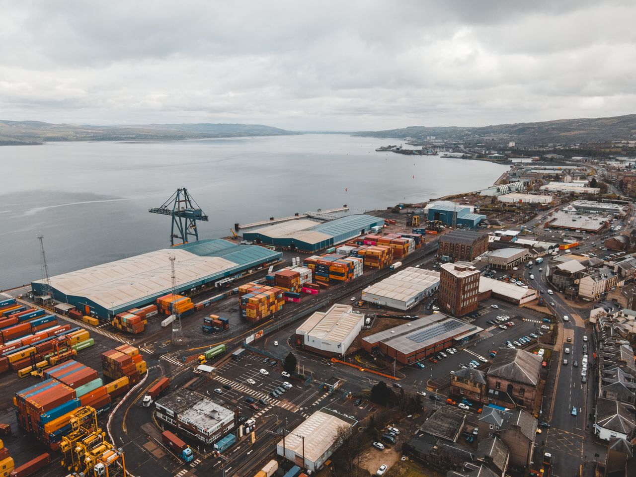 Mastering the First Impression: Your intriguing post title goes here Drone shot of Greenock Harbor, Scotland, showcasing shipping infrastructure by the coast.